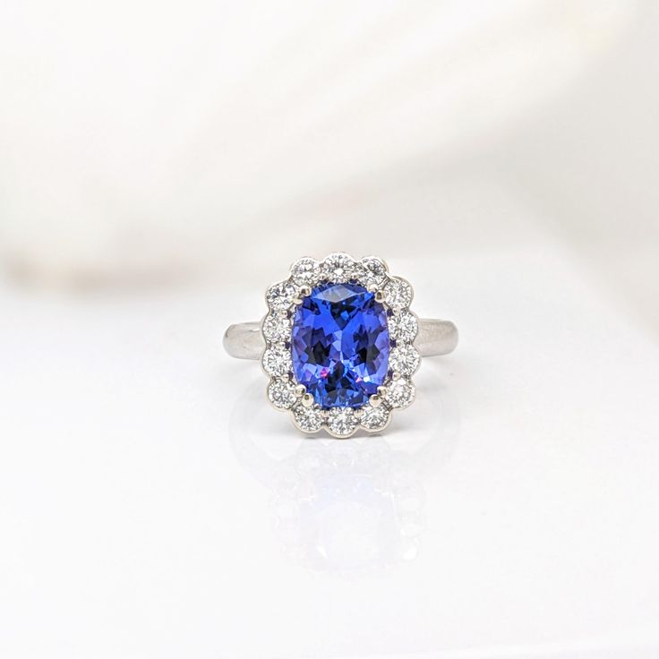 This beautiful ring features a 3.20 carat cushion cut Tanzanite gemstone with natural earth mined diamonds in solid 14K gold. This Tanzanite ring makes a lovely December birthstone gift for your loved ones! This ring is made with solid 14K Gold and natural Earth mined SI / G-H diamonds. As listed, this ring is ready to ship. If you're interested in purchasing this setting with a different center stone please message us! Cushion Cut Diamond Gemstones For Fine Jewelry, Cushion Cut Diamond Fine Jewelry, Fine Jewelry Cushion Cut Gemstone With Center Stone, Classic Cushion Cut Gemstone For Anniversary, Elegant Tanzanite Cushion Cut Ring, Elegant Cushion Cut Tanzanite Rings, Fine Jewelry With Cushion Cut Tanzanite, Cushion Cut Gemstones With Prong Setting, Fine Jewelry Tanzanite Cushion Cut