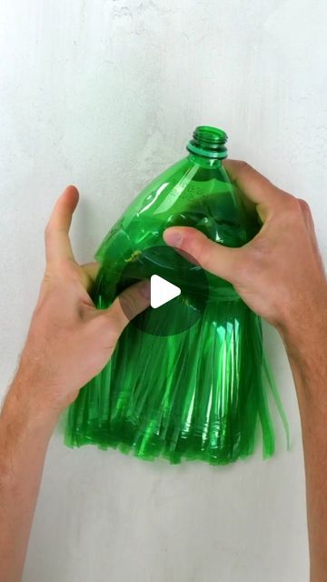 a person holding a green plastic trash bag