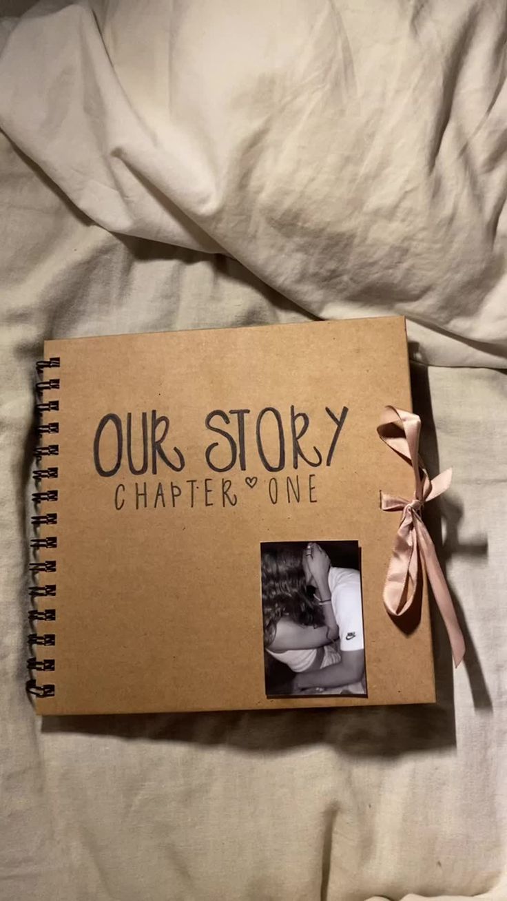 an open book with the words our story written on it and a ribbon tied around the cover