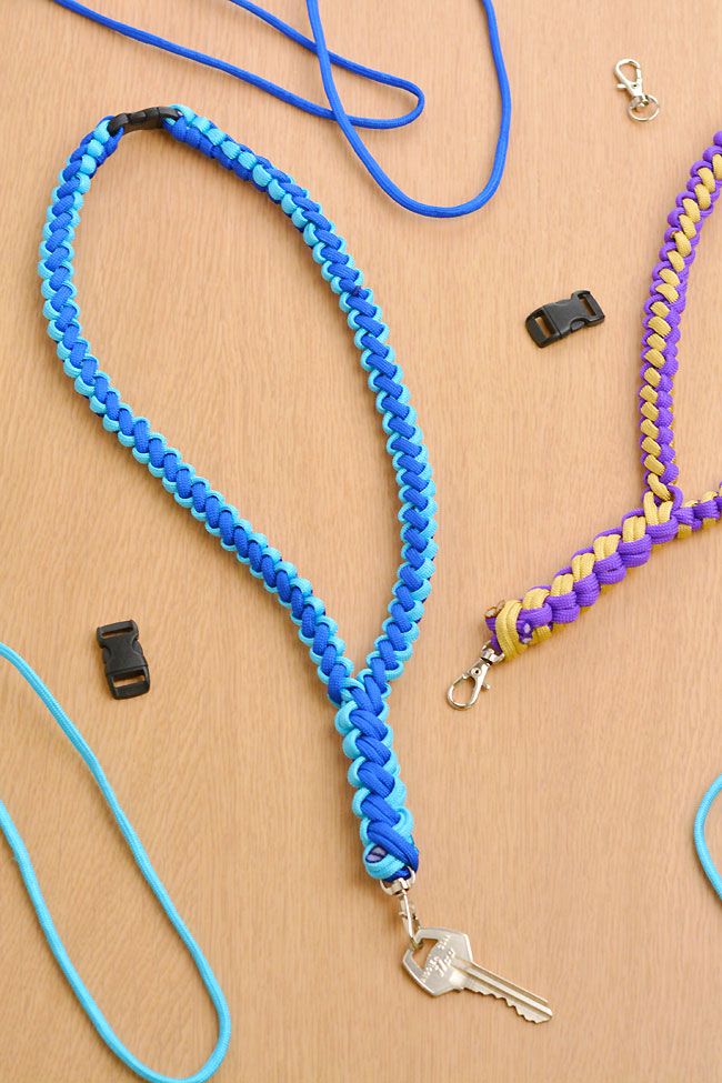 several lanyards are laid out on a wooden table with keys and other accessories