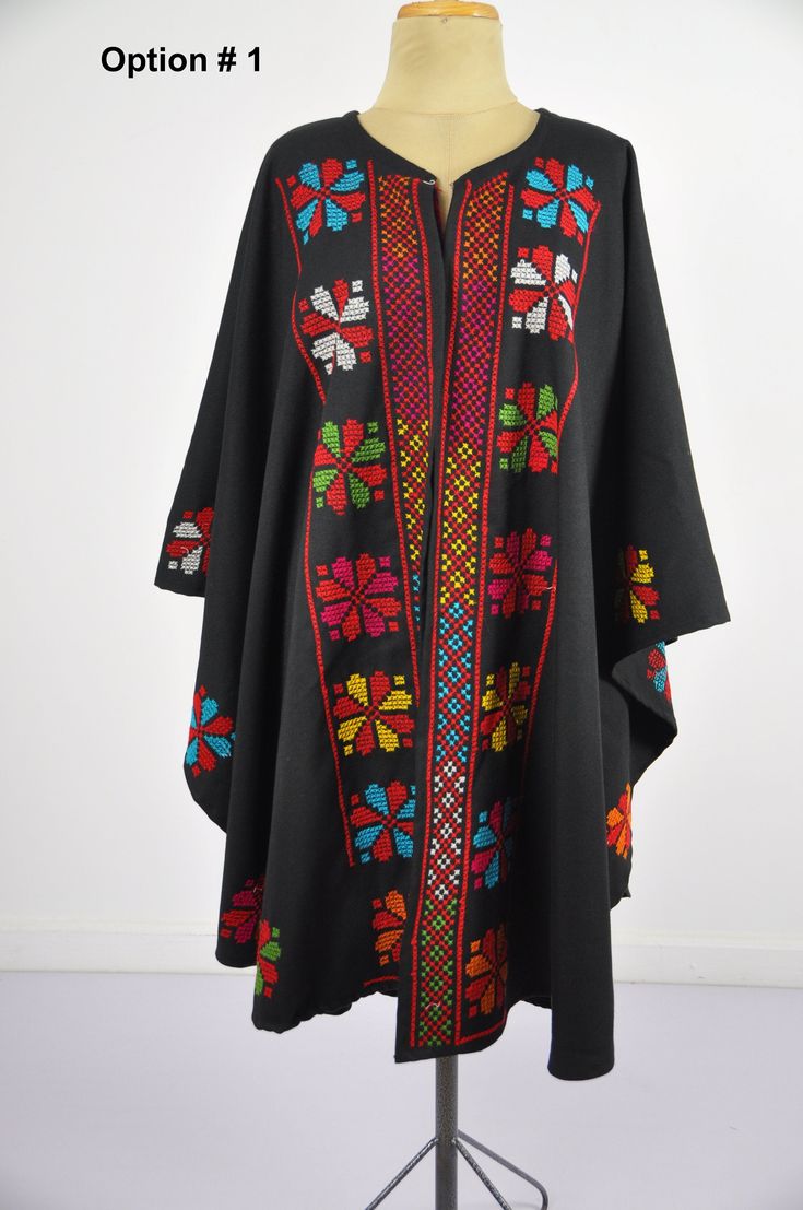 This vintage cape jacket is definitely a vintage fashion statement. It is 100% hand embroidered with geometrical patterns. It can be used over a jeans and shirt or sweater. Great to keep you warm. Please note that the capes we have at the moment (Option #1 and Option #2) are without a hoodie but they are just as beautiful and practical. Material : Wool Length : 49 inches Size : One size fits all. We ship your order with DHL express within one to two business days. Orders to Europe will typically Traditional Black Cape For Fall, Traditional Hooded Winter Poncho, Bohemian Hooded Cape For Festivals, Embroidered Cape Outerwear For Fall, Traditional Black Shawl Outerwear, Traditional Black Cape For Festival, Traditional Black Festival Cape, Winter Festival Embroidered Poncho, Festival Black Embroidered Poncho