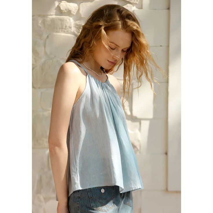 Discover Timeless Elegance Embrace the essence of summer with our Vintage Blue Striped Linen Halter Crop Top. Designed for the fashion-forward woman, this top combines timeless elegance with a modern twist, perfect for those sunny days and balmy evenings. Whether you're heading to a beach party or a casual day out, this top ensures you do it in style. Product Features Crafted from 100% linen, this halter top is all about comfort and breathability, keeping you cool as the temperatures rise. The sleeveless design and back-tie bandage offer a flattering fit, while the subtle stripes add a classic touch to your look. With its versatile and casual style, this top is your go-to choice for effortless summer fashion. Fabric: High-quality, non-stretch linen Design: Sleeveless, halter neckline with