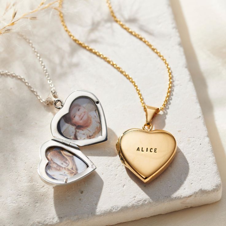 The Personalised Heart Locket is a stunning gift for someone special. The Personalised Heart Locket is a thoughtful way to mark special milestones, Valentine's Day and anniversaries make it truly unique by adding personalisation on the front with a name, date or meaningful word. Choose from the black or clear finish. Inside there is space for 2 photographs keeping your loved ones close to heart. Choose from silver, 18ct rose or yellow gold plate, each Personalised Heart Locket is made to order i Silver Locket Jewelry For Mother's Day, Dainty Engraved Sterling Silver Locket Necklace, Mother's Day Silver Locket Jewelry, Dainty Personalized Open Heart Locket Necklace, Pendant Locket Necklace For Mother's Day Keepsake, Mother's Day Keepsake Pendant Locket Necklace, Classic Jewelry For Anniversary And Mother's Day, White Gold Locket Necklace For Mother's Day Keepsake, Elegant Birthstone Locket Necklace Gift