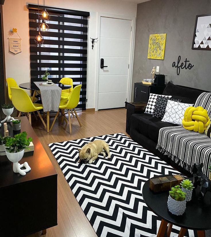 a black and white living room with yellow accents