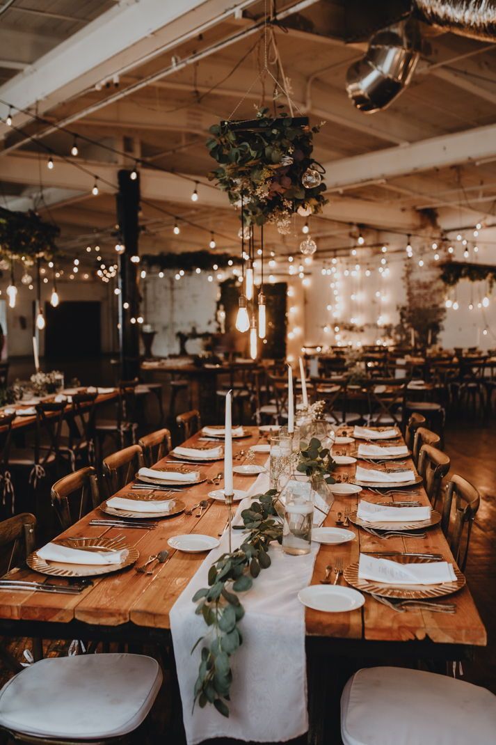 a long table with white plates and place settings