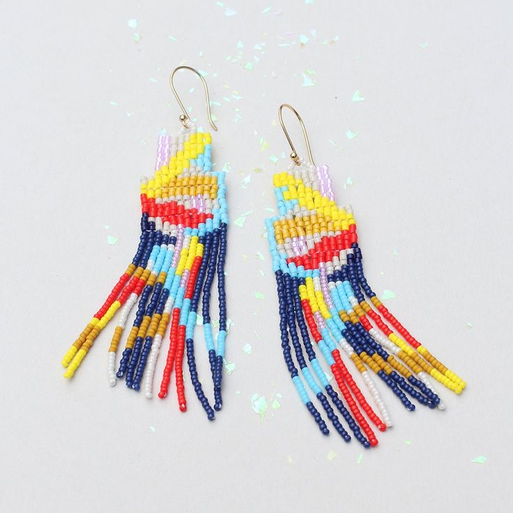 Striking abstract beaded earrings. Cascades of color evoke a canyon trail.Glass beads, gold-plate French ear wire. 3 3/4" x 1".Made by artisans in Guatemala. Fringe Earring, Beaded Chandelier Earrings, Beaded Earrings Tutorials, Arrow Earrings, Brick Stitch Earrings, Earring Tutorial, Beaded Hoop Earrings, Beaded Hoops, Seed Bead Earrings