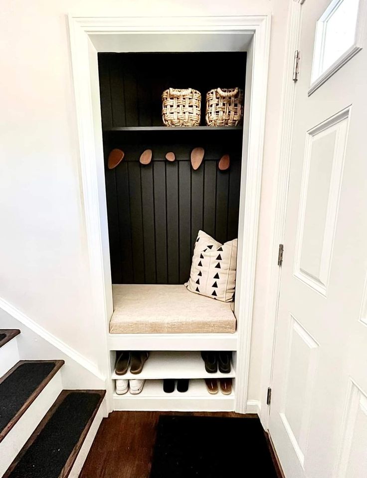 an entry way with a bench and some shoes