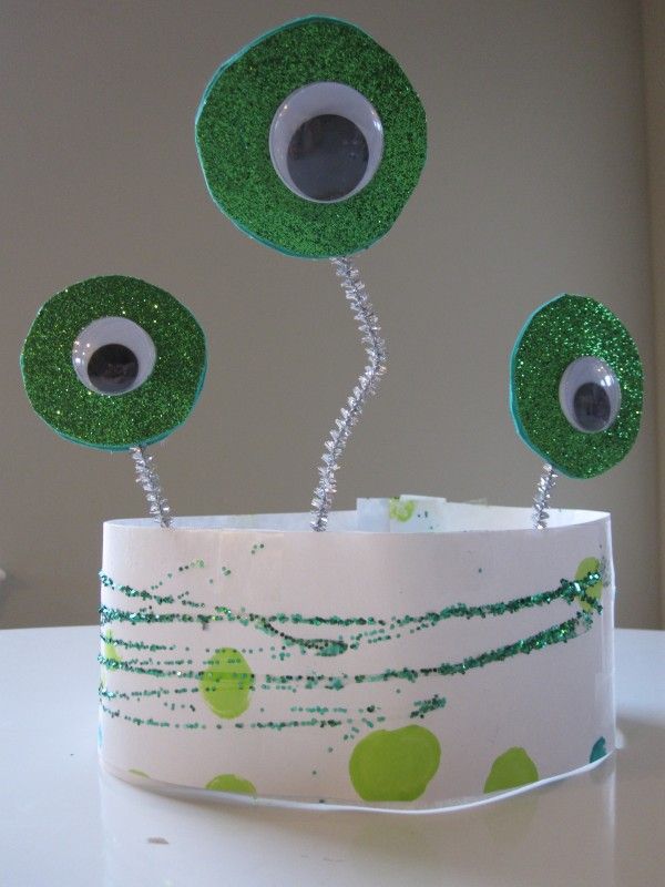 three green eyeballs sitting on top of a white table