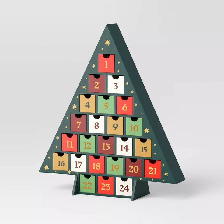 a christmas tree shaped like a calendar with numbers on the front and sides, all in different colors