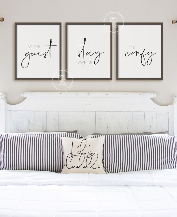 three framed art prints hanging on the wall above a bed with pillows and striped pillow