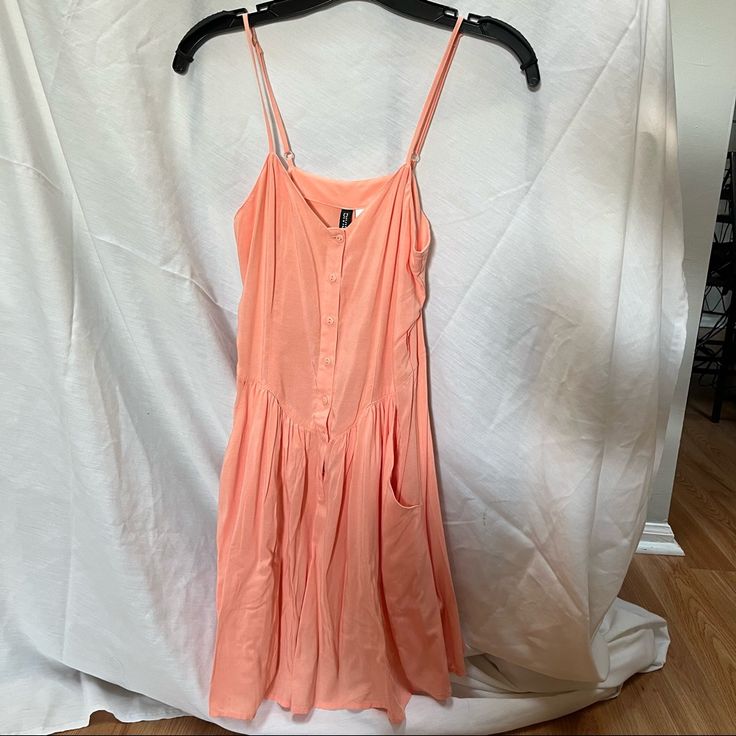 Never Worn Peach Color Dress With Adjustable Straps. Buttons Down The Middle And Deep Pockets. Summer Peach Mini Dress For Day Out, Spring Peach Sundress For The Beach, Spring Peach Sundress For Beach, Spring Peach Beach Sundress, Peach Sleeveless Sundress For Day Out, Peach Sundress Mini Dress For Summer, Peach Sundress Mini Dress For Day Out, Peach Sundress For Summer, Peach Mini Sundress For Summer