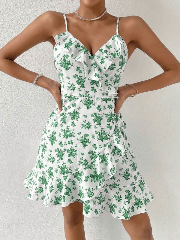 This beautiful WYWH Floral Print Ruffle Trim Wrap Knot Side Cami Dress is the perfect addition to your summer wardrobe. Its lightweight and flowy fit is crafted from 95% Polyester and 5% Elastane fabric, with fresh all-over floral print accents and ruffle and wrap detail that add a touch of boho-chic to your look. The sleeveless spaghetti strap dress features a high waist and regular fit, perfect for twirling in the sunshine. Style: Boho Pattern Type: Floral, All Over Print Details: Ruffle, Wrap Green Ruffled Mini Dress For Summer, Summer Chiffon Dresses With Ruffles, Summer Chiffon Dress With Ruffled Straps, Summer V-neck Ruffle Dress For Garden Party, Flirty V-neck Ruffle Dress For Summer, Chiffon Summer Dress With Ruffled Straps, Chiffon Dress With Ruffle Hem For The Beach, Chiffon Mini Dress With Ruffle Hem For Beach, Green Mini Ruffle Dress For Summer