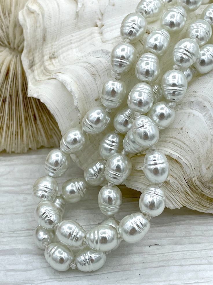 Hand Knotted Necklace Are you looking for a timeless piece of jewelry that will add a touch of elegance to your look? Look no further than this Hand Knotted Potato Shape Glass Pearl Necklace! This stunning necklace features 10mm x 8mm glass pearls that are hand-knotted on a 18" long string. Choose between a double gold clasp or a silver bean clasp, both of which are made of plated brass. Plus, this necklace is lead and nickel safe and ships fast with orders placed by 11:00 am EST Monday-Friday s Vintage White High Luster Jewelry, Hand Knotted Necklace, Knotted Necklace, Knot Necklace, Stunning Necklace, Vintage Porcelain, Monday Friday, Timeless Pieces, Fresh Water