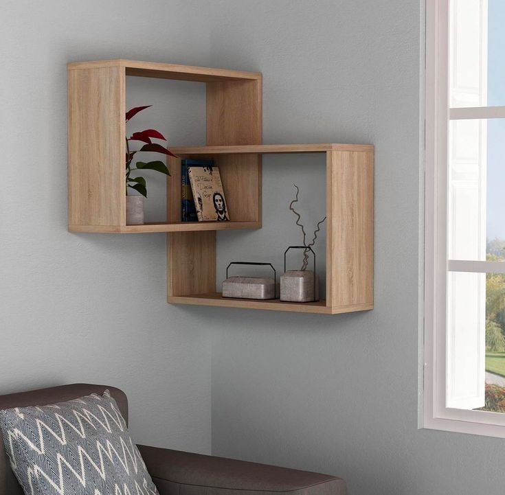 a living room with a chair and some shelves on the wall