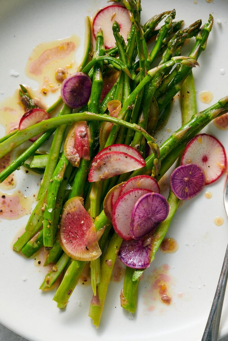 asparagus and radishes on a white plate