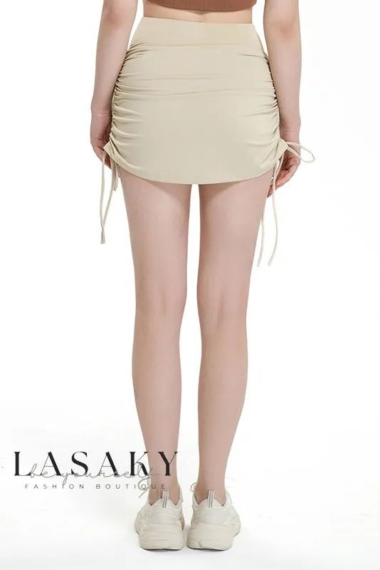 Lasaky - Premium Quick-Dry Tennis Leggings with High-Waist and Booty-Enhancing Skirt - Ideal for Yoga Beige Stretch Mini Skirt For Summer, Fitted Skirt For Beach, Stretch Drawstring Skirt Bottoms, Drawstring Skirt Bottoms For Spring, Solid Color Bottoms With Tie-side And Elastic Waistband, Drawstring Skirt For Spring, Spring Drawstring Skirt Bottoms, Spring Stretch Skirt With Tie-side Bottom, Fitted Beach Skirt