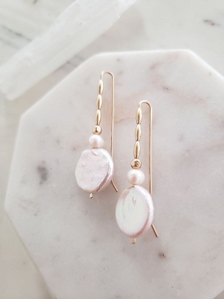 These earrings are unique yet perfectly on trend and timeless. Perfect for dressing up a casual look or for a bride on your wedding day! Handmade from top quality materials. Genuine lustrous freshwater coin pearls are threaded with 14k gold filled beads on 14k gold filled wire. Gold fill does not wear off like gold plated. Water safe! Hypoallergenic, lead and nickel free. Comfortable and lightweight! Come packaged in a gift box. **What is 14k Gold-fill?** Gold fill does not tarnish or wear off a Feminine Pearl Earrings With Pearl Chain, 14k Gold Filled Pearl Drop Earrings For Anniversary, Pearl White Pearl Drop Linear Earrings, Pearl White Linear Pearl Drop Earrings, Delicate Pearl Drop Linear Earrings, Feminine Pearl White Earrings With Pearl Drop, Delicate Pearl White Pearl Drop Earrings, Feminine Pearl White Drop Bridal Earrings, Feminine Pearl Earrings