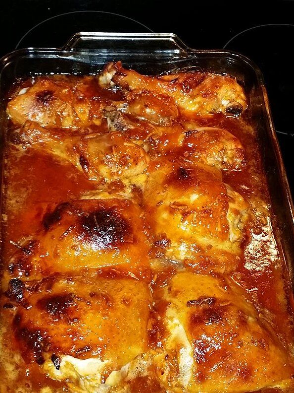 a casserole dish with meat and sauce in it on the stove top, ready to be eaten