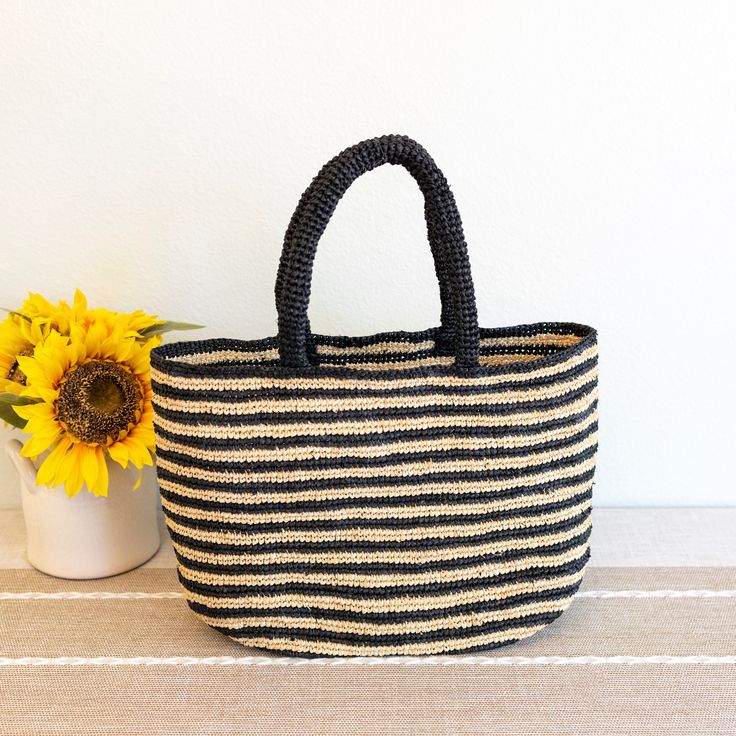 IN STOCK FAST SHIPPING FROM LOS ANGELES Take your beach style to the next level with our Elena Handbags Raffia Summer Beach Striped Straw Tote Bag! This bag features a classic and stylish striped design, perfect for any summer outing. Made with durable raffia material, it's the ideal choice for all your beach essentials. (No more sandy bags!) Natural Raffia Straw Handmade Unlined Size: 10"H x 16"W Handle drop length: 7" Designer Style ID: 8695 Beach Bag With Braided Handles, Chic Beach Straw Bag With Top Handle, Chic Top Handle Straw Bag For Beach, Chic Vacation Beach Bag With Top Handle, Chic Top Handle Beach Bag For Vacation, Black Rectangular Beach Bag, Summer Crochet Bag With Rolled Handles For Vacation, Summer Vacation Crochet Bag With Rolled Handles, Summer Travel Crochet Bag With Rolled Handles