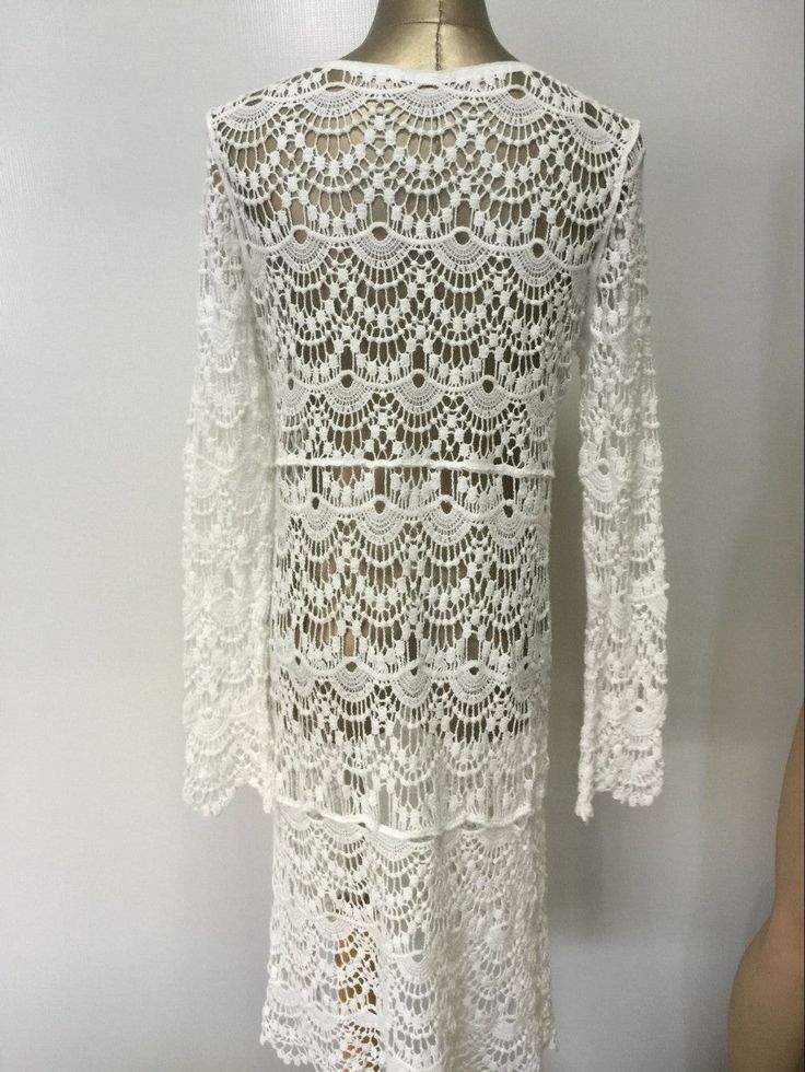 Material: Acrylic, CottonDecoration: Hollow OutSleeve Length: Full SleeveCollar: V-Neck V-neck Crochet Lace Dress For Beach Cover-up, Elegant Open Knit Crochet Dress For Vacation, Elegant Crochet Lace Dress For Vacation, Elegant Crochet Lace Dress For The Beach, White Long Sleeve Bohemian Crochet Dress, Vacation Crochet Lace Dress With Open Knit, Bohemian Crochet Dress With Lace Trim And Long Sleeves, White Bohemian Crochet Dress With Hollow Out Details, Bohemian Long Sleeve Crochet Dress With Lace Trim