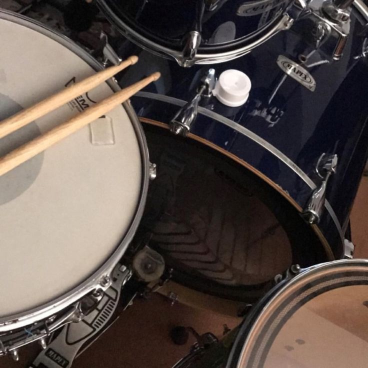 a drum set with two sticks resting on it