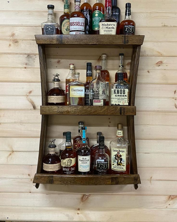 two wooden shelves filled with different types of liquor