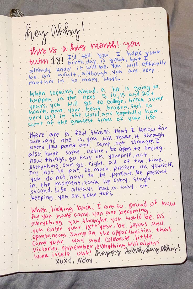 an open notebook with writing on it that has been written in different colors and sizes