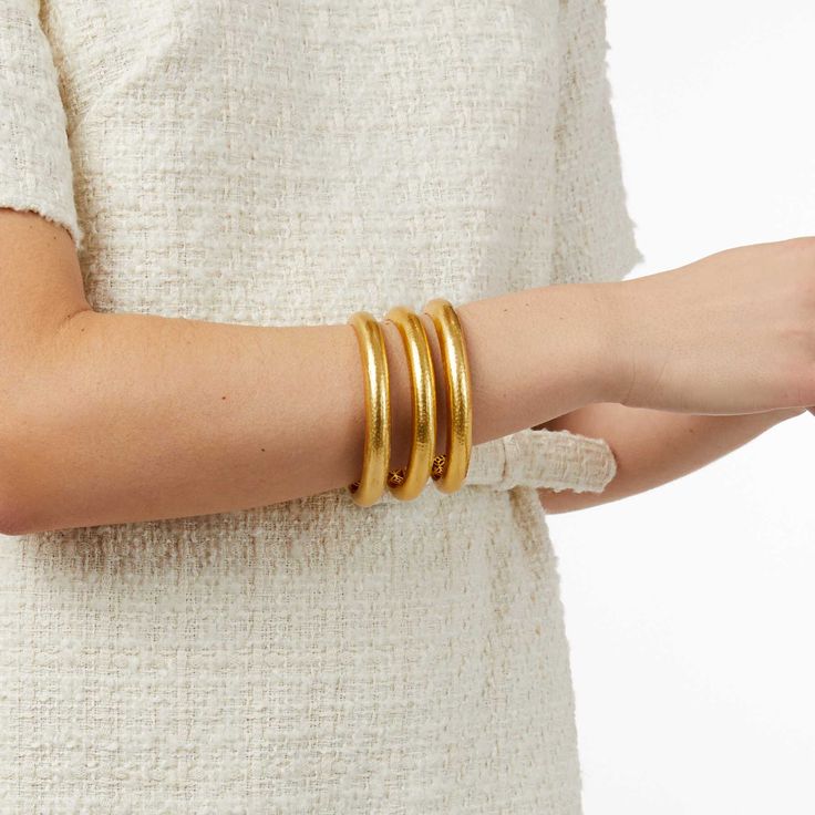 Elegant yet simple, this statement-making golden bangle features a lightly hand-hammered finish. An ornately geometric piercework interior adds lightness and luxury for wearing stacked or solo. Golden Bangles, Active Wear Dresses, Arm Accessories, Julie Vos, Stackable Bangles, Gold Plated Bangles, Stacked Bangles, Holiday Items, Bold Fashion