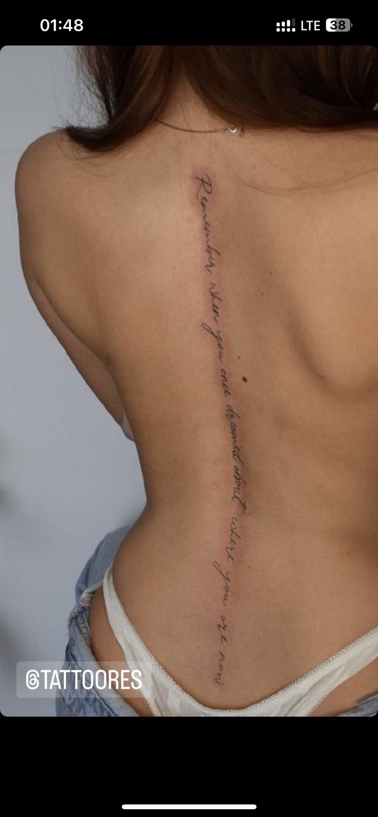 the back of a woman's lower back with writing on her upper and lower back