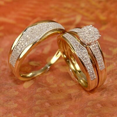 two gold wedding rings sitting on top of an orange cloth covered floor with small white diamonds