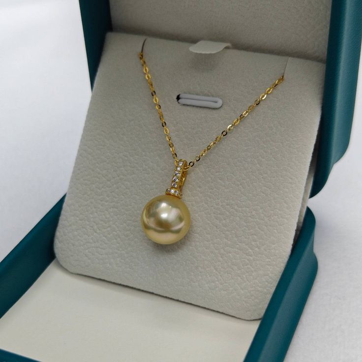 12mm Golden South Sea Pearl &Seren Pendant NecklaceAdorn yourself with opulence with our 11-12mm Golden South Sea Pearl Pendant. This exquisite jewelry piece features a lustrous golden pearl suspended in timeless elegance. Crafted with precision, the pendant exudes luxury and sophistication, making it a perfect accessory for any special occasion. Elevate your style with this radiant and rare treasure. Material: 18k pure gold with Golden South Sea Pearl, cubic zirconia and 18k gold chain necklace South Sea Pearl Necklace, Golden Pearl, Golden South Sea Pearls, 18k Gold Chain, Sea Pearl, South Seas, South Sea Pearls, Pearl Types, Pearl Pendant Necklace