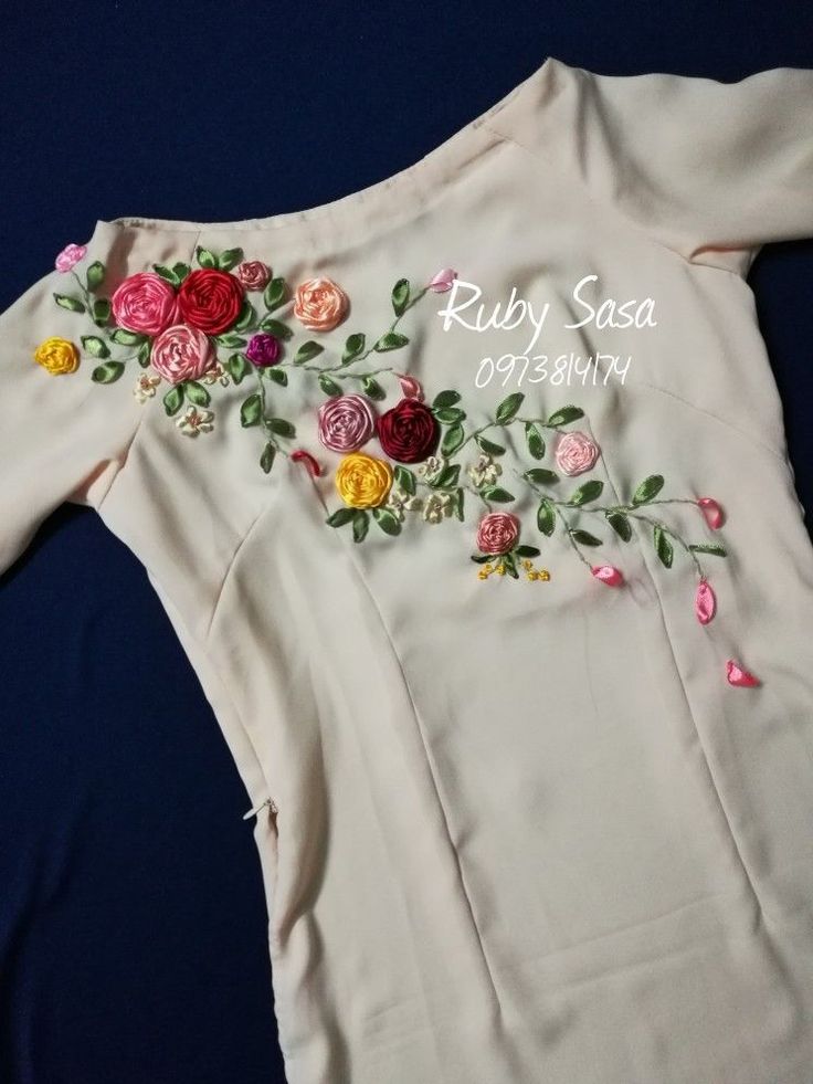 a white shirt with flowers on it and the words ruby sasa written in cursive writing