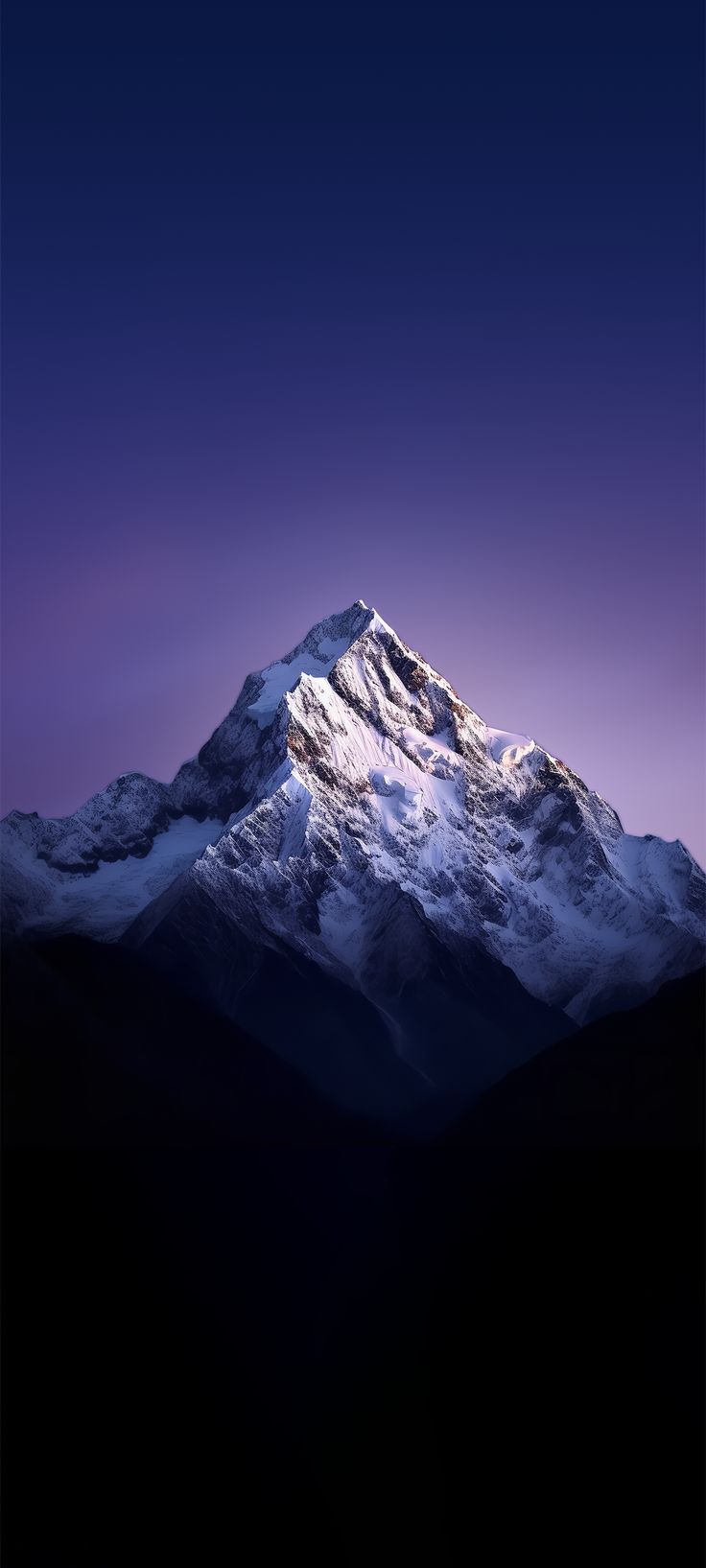 the top of a snow covered mountain under a purple sky