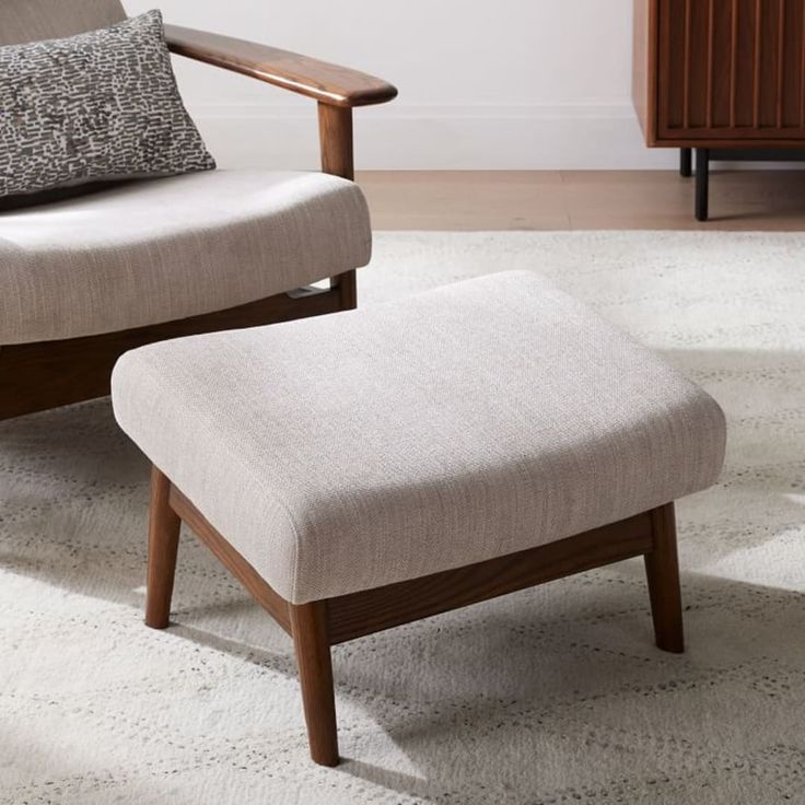 a chair and footstool in a living room