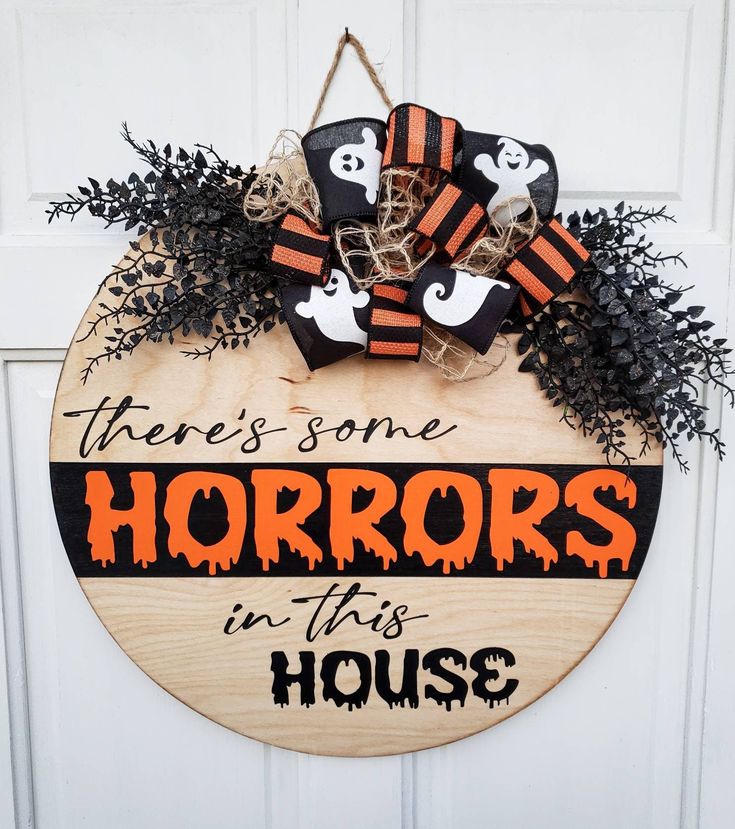 a wooden sign that says, there's some horrors in this house