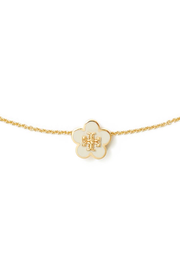 A flower-shaped logo medallion brings a pretty focal point for this delicate goldtone necklace. 16" length; 2" extender; 3/8" diameter pendant Goldtone plate/enamel Imported Evry Jewels Necklaces Stack, Cool Gold Necklaces, Enewton Necklace, Christmas List Items, Trendy Things, Tory Burch Necklace, Evry Jewels, Jewelry Stack, Cute Necklaces