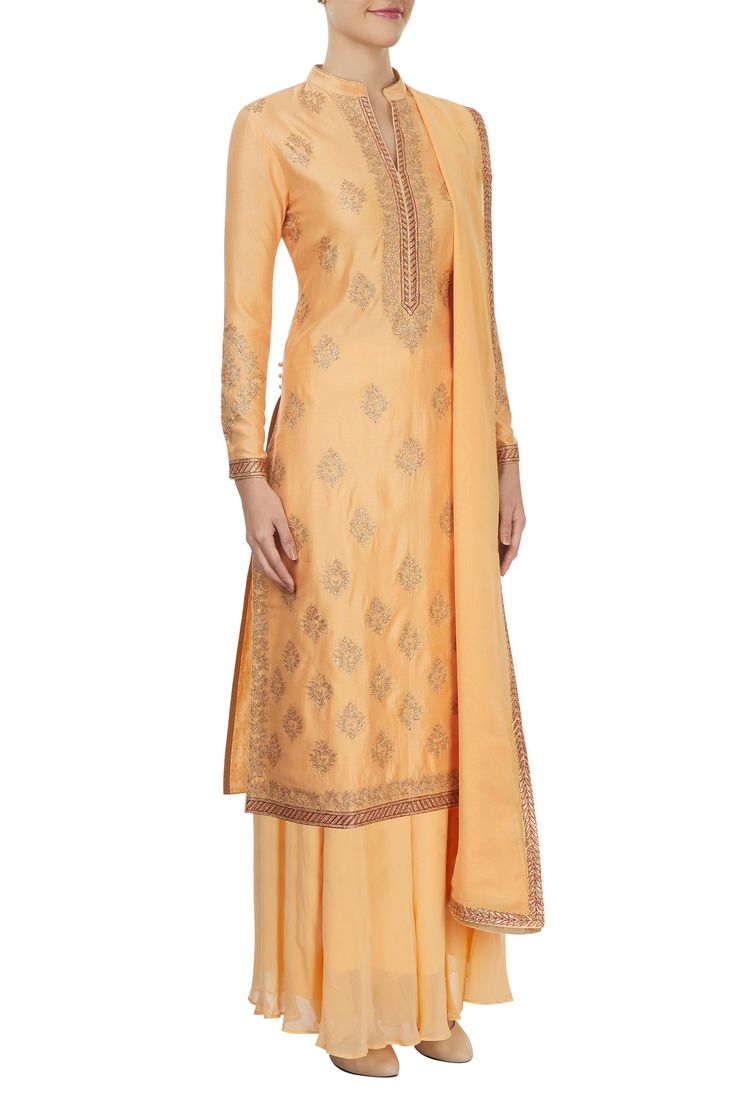 Peach long kurta with all-over dori embroidered motifs in gold accents. Paired with palazzo and a dupatta.
Components: 3
Pattern: Embroidered
Type of Work: Dori work
Neckline: V-neck
Sleeve length: Full
Fabric: Chanderi
Color: Peach
Other details:
Side slits
Ethnic motifs - Aza Fashions Gold Palazzo Set With Intricate Embroidery And Straight Kurta, Gold Chanderi Palazzo Set With Intricate Embroidery, Gold Palazzo Set With Zari Work For Formal Occasions, Gold Palazzo Set With Zari Work For Formal Events, Formal Gold Palazzo Set With Zari Work, Gold Palazzo Set With Resham Embroidery For Formal Occasions, Traditional Gold Palazzo Set With Intricate Embroidery, Formal Gold Palazzo Set With Resham Embroidery, Formal Festive Sharara With Gold Embroidery