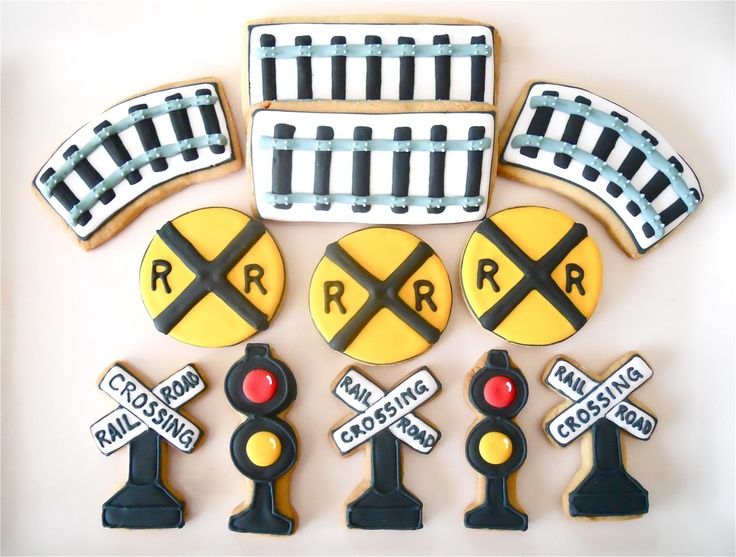 decorated cookies with railroad tracks and stoplights on them are displayed in front of a white background