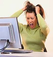 a woman with her hands on her head in front of a computer screen, screaming