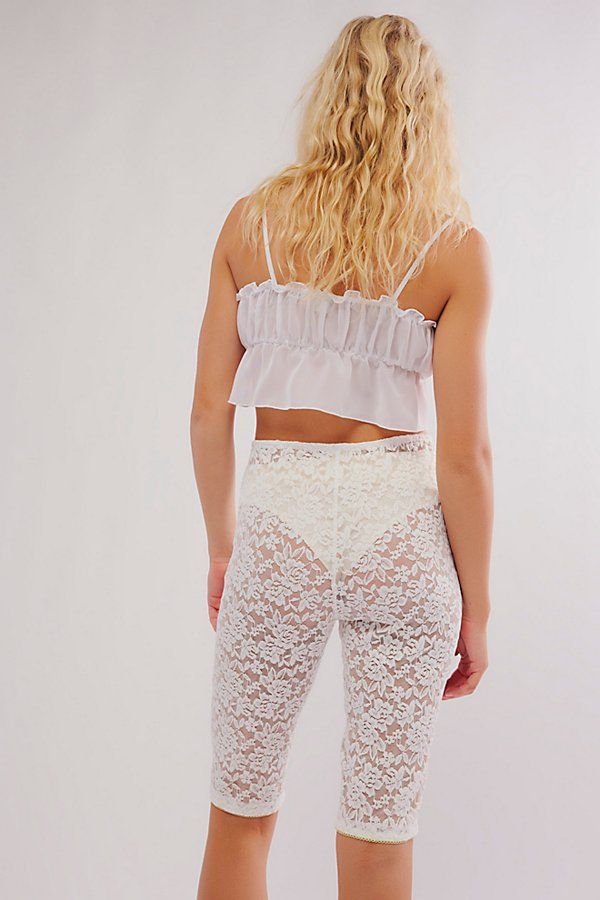 So lovely in lace, these floral-adorned capri pants are featured in a high-rise silhouette and slim-fitting style with bow-tie detail at the center-front and picot trim. **Fit:** High-rise, fitted silhouette, knee length **Features:** Sheer lace fabrication with floral detailing, elasticated waistband, bow-tie at center-front, defined seams, picot trim **Why We ❤ It:** These lace pants can be layered underneath all your favorite dresses and skirts or paired with a tunic. | All Day Lace Capris by Fitted Lace Bottoms For Daywear, Feminine Scalloped Lace Bottoms, Chic Fitted Bottoms With Delicate Lace, Stretch Summer Bottoms With Delicate Lace, Flirty White Bottoms With Lace Trim, Feminine Lace Lounge Bottoms, High Waist Bottoms With Lace Trim For Daywear, Summer Lace Pants With Lace Trim, Fitted Flirty Bottoms With Lace Trim