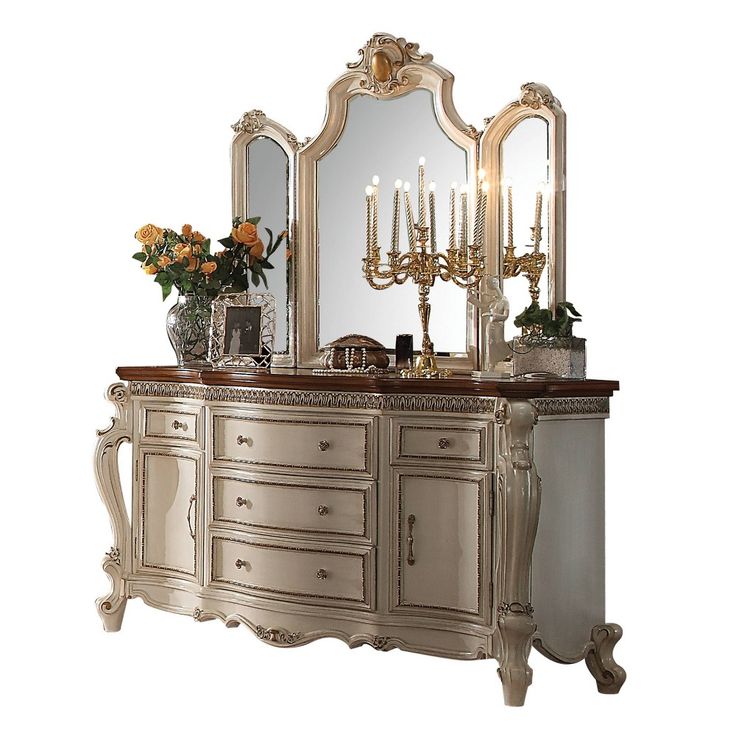 an ornately decorated vanity with candles and flowers