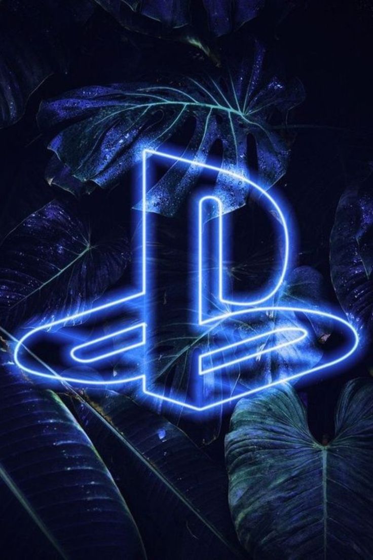 the playstation logo is lit up in blue and surrounded by tropical leaves on a dark background