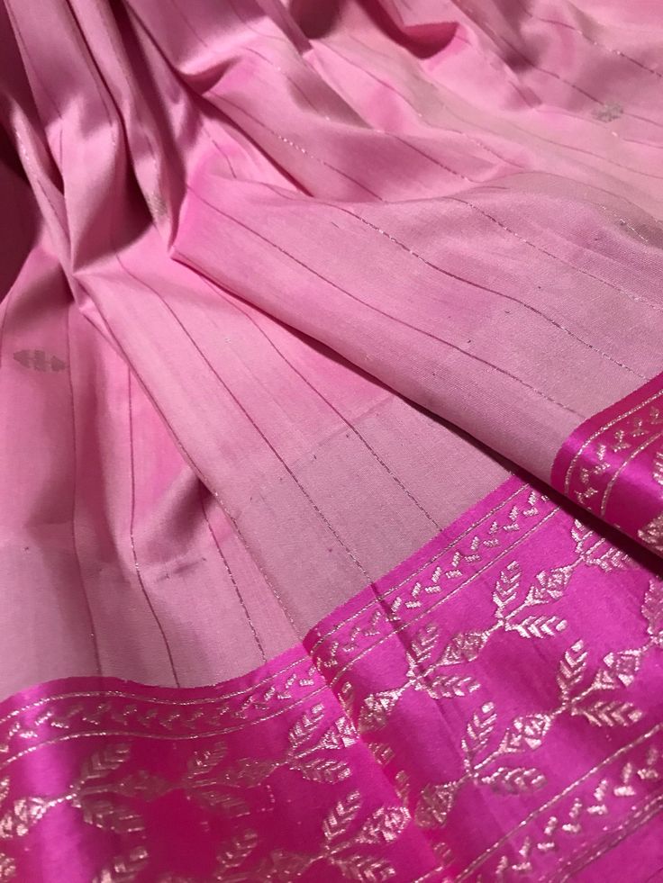 This is. a banarasi SILK By SILK COTTON saree in candy pink with pinkish zari lines running vertically all over the body. Muted silverish gold zari pallu and woven zari motifs complete this saree. Saree is finished with tassels and falls and pico are already  done.  Saree comes with an unstitched blouse piece(last picture) *Handloom products may have some irregularities  *Colour may vary slightly due to lighting  *Dry clean only *All sales are final Pink Cotton Silk Traditional Wear With Dupatta, Pink Cotton Silk Traditional Wear For Festive Season, Festive Pink Cotton Silk Traditional Wear, Elegant Pink Slub Silk Dupatta, Bollywood Style Pink Cotton Silk Traditional Wear, Unstitched Pink Slub Silk Traditional Wear, Semi-stitched Pink Slub Silk Traditional Wear, Festive Pink Slub Silk Traditional Wear, Festive Pink Traditional Wear In Slub Silk