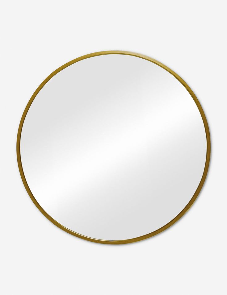 a round mirror with a gold rim