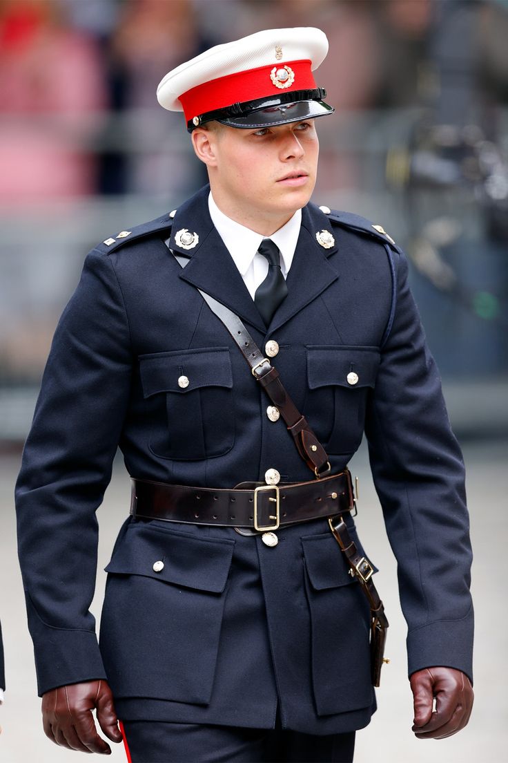 a man in uniform is walking down the street