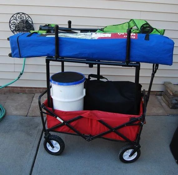 a blue and red cart with some items on the back in front of a house