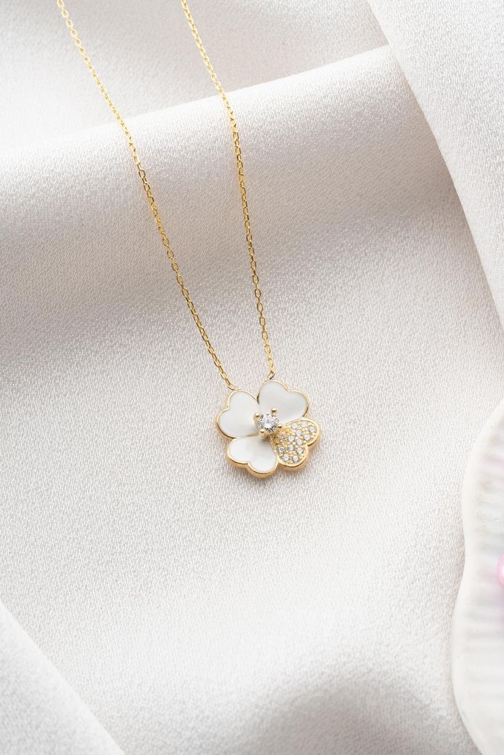 Pure White Clover Necklace, 925 Sterling Silver,  Four Leaf Clover Pendant, Tiny Floral  Necklace, Lucky Clover Pendant, Irish Shamrock Charm, Heart Clover Charm, Anniversary Gifts, Perfect Gift for Her 🍀✨ In the purity of white clover, grace and luck intertwine, where the pristine petals hold the secret to a world blanketed in the elegance of white. 🍀✨ Materials: High Quality 925 Sterling Silver * Zircon Stone * Rose Gold Plating Chain: 925 Sterling Silver Chain is included in price. Chain Length: 17 inches (42 cm) Pendant width: 0.55 inches (1.40cm) Pendant height: 0.55 inches (1.40cm) ✔️ FREE & Express SHIPPING to the US, Canada, UK and EU countries. ✔️ All your orders are shipped with a valid tracking code. ✔️ Premium Packaging with all orders ready to gift ✅ Care Instructions: You s Sterling Silver White Clavicle Chain, White Flower Charm Necklace Fine Jewelry, White Fine Jewelry Necklaces With Flower Charm, Fine Jewelry With White Flower Charm, White Sterling Silver Clavicle Chain, White Sterling Silver Clavicle Chain Jewelry, White Sterling Silver Necklace As Gift For Her, White Fine Jewelry With Flower Charm, Fine Jewelry White Flower Necklace