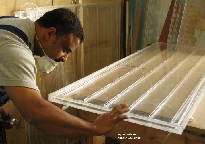 a man is working on some plastic trays