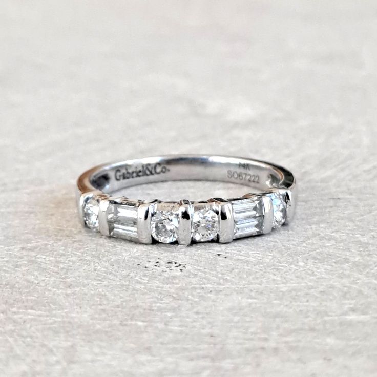 Baguette & Round Brilliant .54 Ctw Diamond Wedding Band Ring, 14K White Gold, Gorgeous Estate Piece, GIA G.G. Appraisal Incl 1,620 Usd! This fabulouse band is in excellent condition and it sparkles beautifully. It measures 3.1mm wide at front and 2.4mm wide at back of shank. Inside the shank is stamped with "Gabriel&Co.", "14K", and "SO67222". An independent GIA Graduate Gemologist has performed an appraisal and a copy will be included with your purchase! Here are the specific findings: Ladies 1 Diamond White Platinum Baguette Cut Wedding Ring, Baguette Cut Diamond White Platinum Wedding Ring, Dazzling Baguette Cut Rings For Anniversary, Dazzling White Gold Wedding Ring Baguette Cut, Dazzling White Gold Baguette Cut Wedding Ring, Dazzling Baguette Cut White Gold Wedding Ring, Luxury Platinum Half Eternity Wedding Ring, Luxury Platinum Half Eternity Wedding Band, Dazzling Channel Set Wedding Jewelry