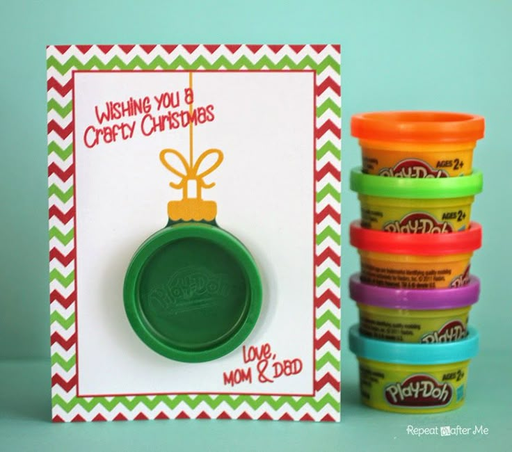 a christmas card with colorful cups and a green rubber stamp that says wishing you a merry christmas